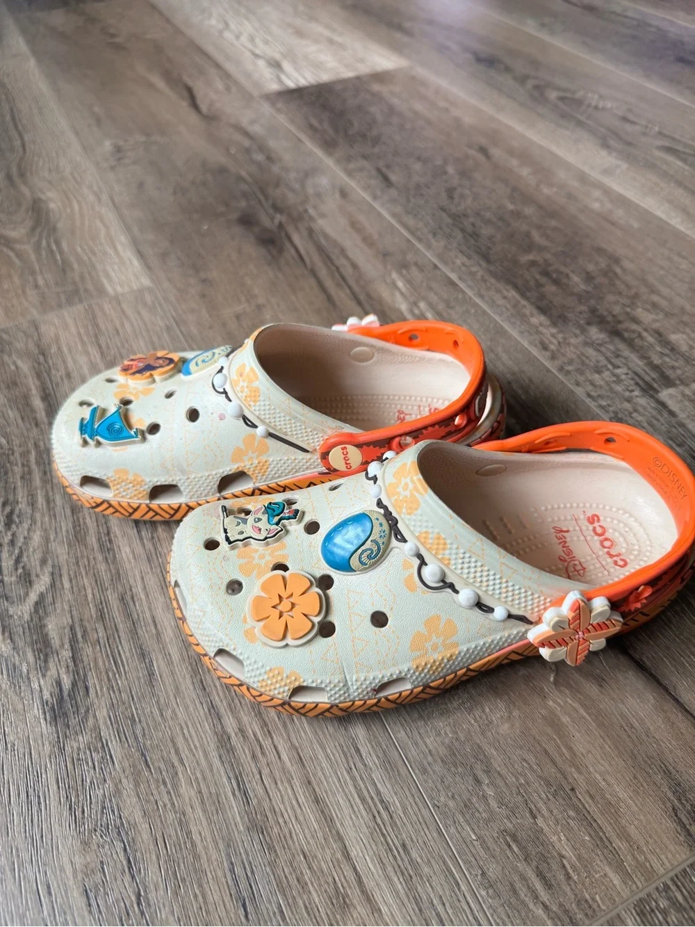 Disney Moana CROCS Kids Beige Clogs with Bright Orange Trim and Colorful Charms